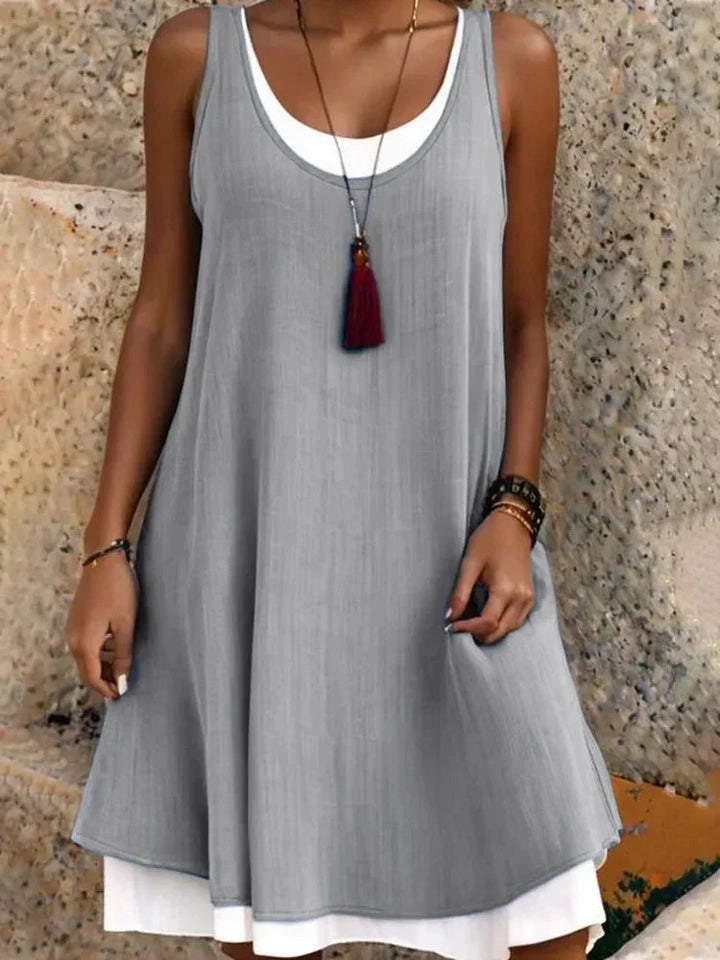 Comfortable women's summer swing dress, featuring a sleeveless scoop neck, layered mini design, great for casual outings.