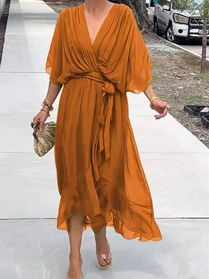 Woman wearing elegant V-neck belted chiffon midi dress, perfect for a party or evening.