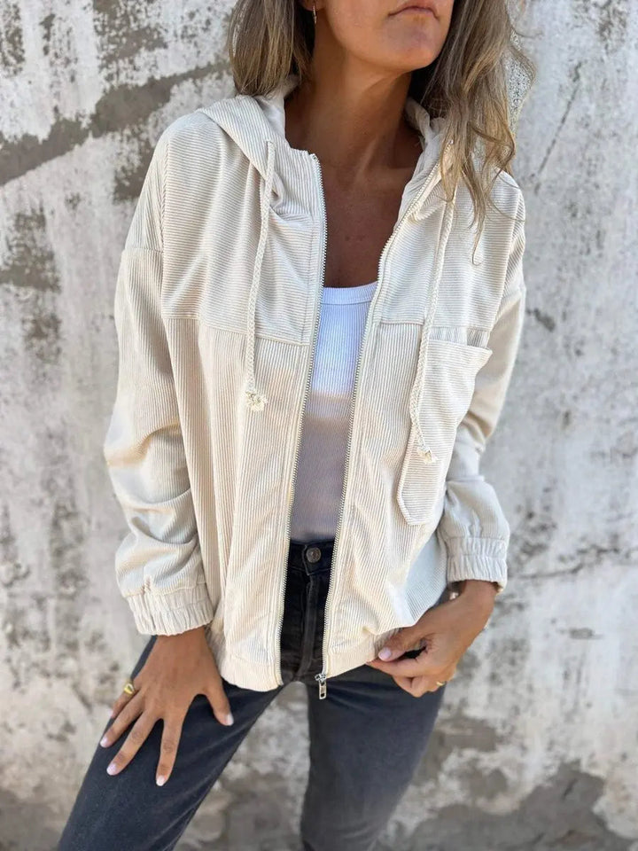 Trendy women's hooded corduroy quilted jacket. Zip-up, oversized, and relaxed fit. Essential outerwear for fall fashion.