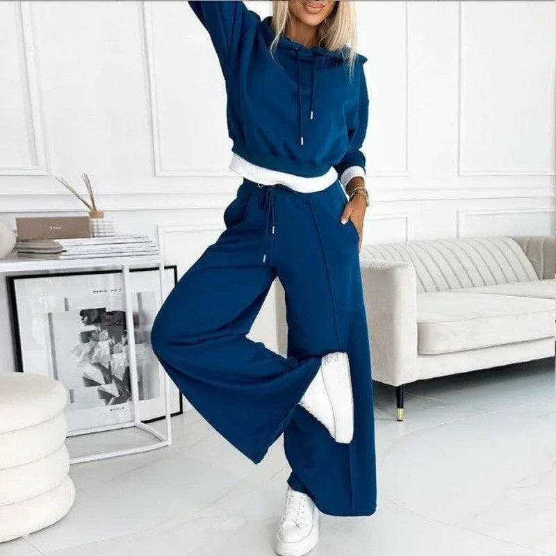 Modern women's relaxed fit loungewear set. Comfortable drawstring hoodie paired with stylish wide-leg pants.