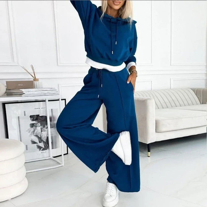 Modern women's relaxed fit loungewear set. Comfortable drawstring hoodie paired with stylish wide-leg pants.