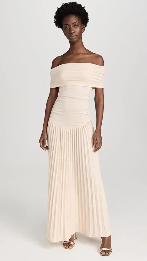 Close-up of the flowy cream fabric on a women's off-shoulder maxi dress, comfortable summer style.