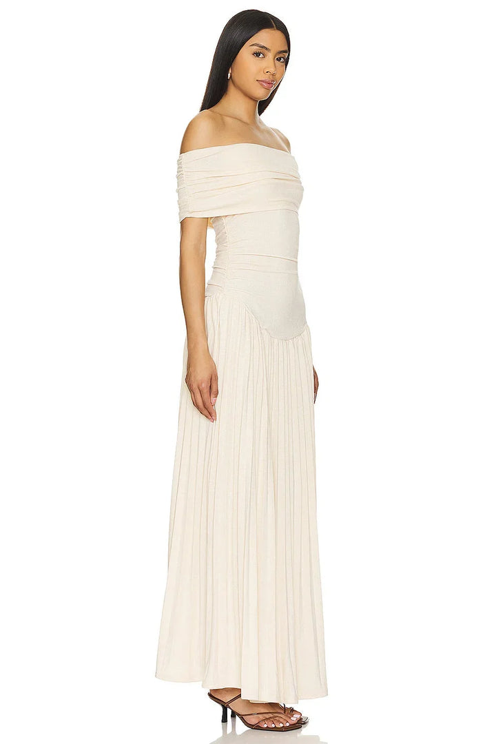 Full length shot of a women's cream off-shoulder flowy maxi dress, perfect for summer holidays.