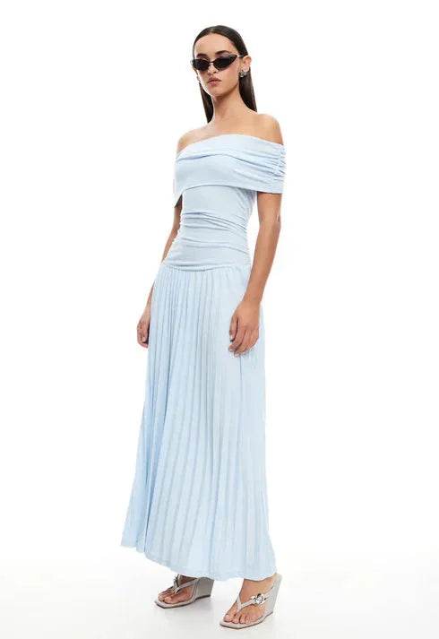 Textured detail of a cream flowy off-shoulder maxi dress, comfortable women's summer attire.