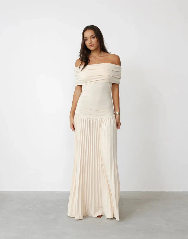 Women's flowy off-shoulder cream maxi dress with pleated skirt, elegant summer style for vacation.