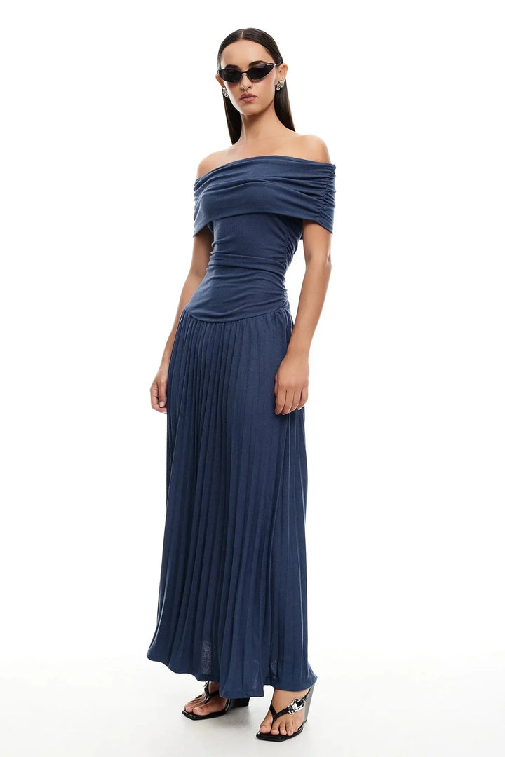 Women's elegant cream off-shoulder flowy maxi dress, perfect summer style with pleated skirt.