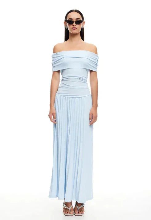 Side view of a women's cream flowy off-shoulder maxi dress, elegant summer style.