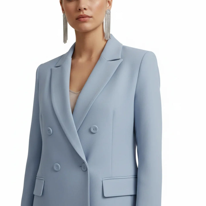 Women's formal double-breasted blazer and matching tailored trousers set.