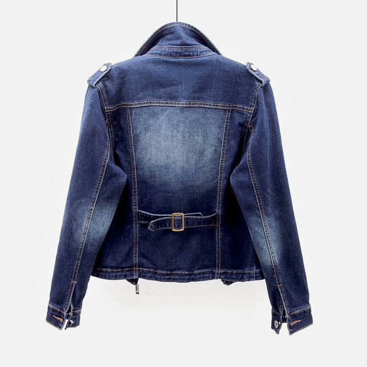 Detail of the button closure on a women's denim jacket.