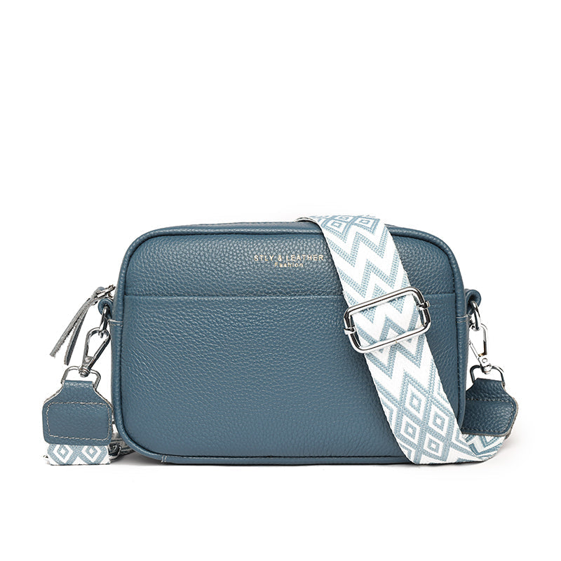 "Women's elegant beige leather crossbody bag with pebbled texture and adjustable strap, perfect for versatile fashion styling