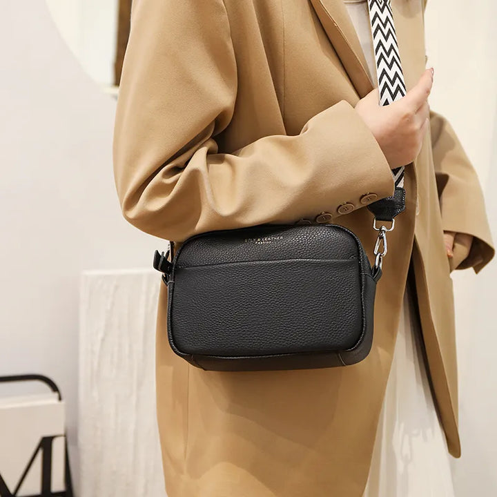 "Women's elegant beige leather crossbody bag with pebbled texture and adjustable strap, perfect for versatile fashion styling