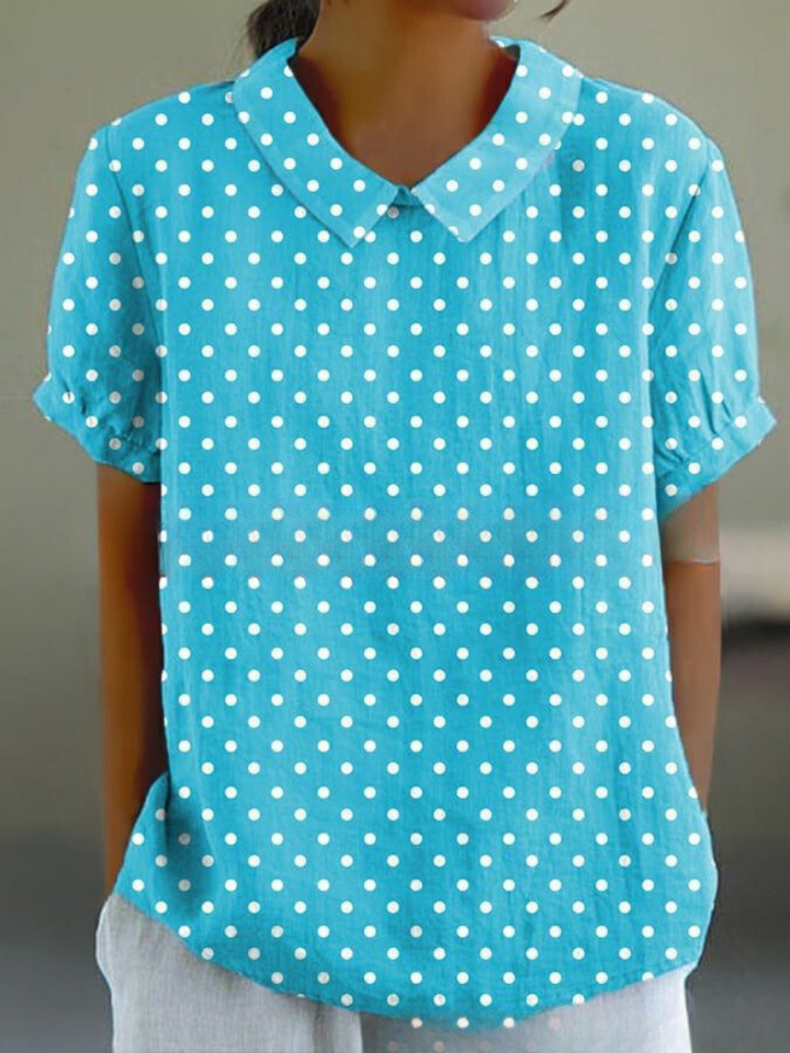 Women's elegant floral blouse with short sleeves and Peter Pan collar, featuring a vibrant floral pattern for stylish summer 