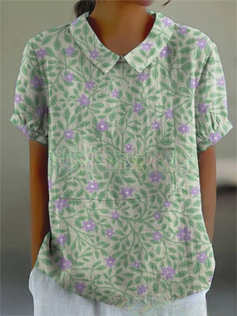 Women's elegant floral blouse with short sleeves and Peter Pan collar, featuring a vibrant floral pattern for stylish summer 