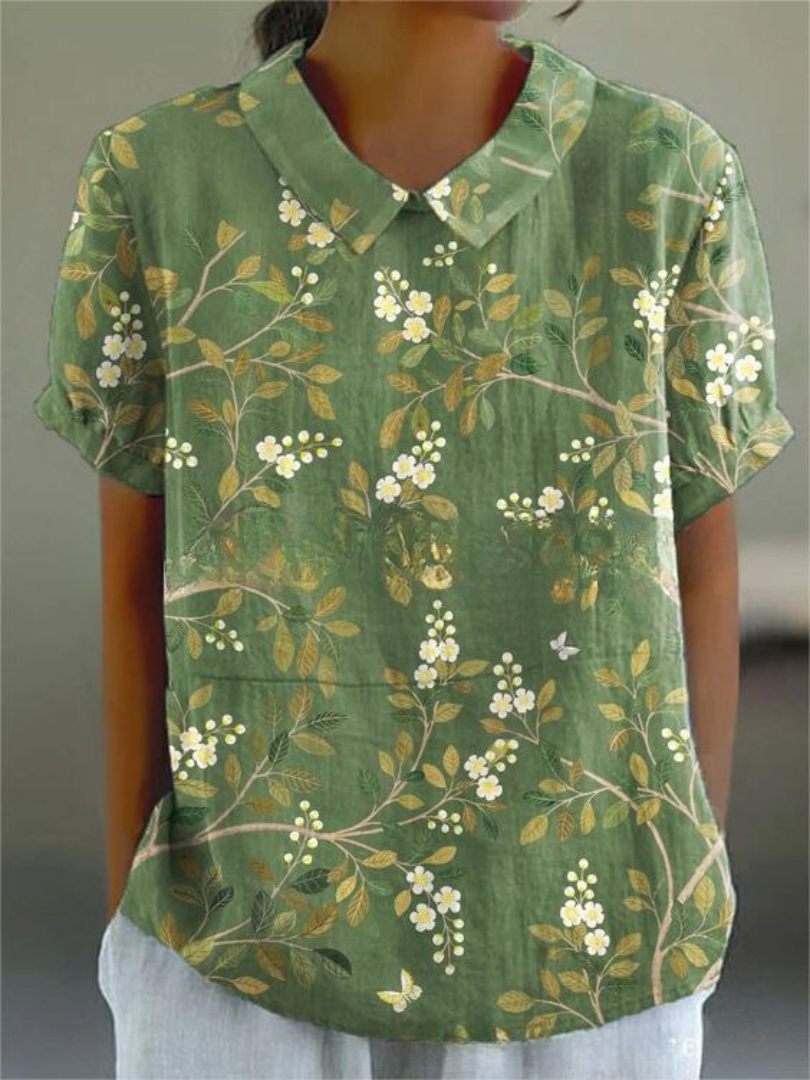 Women's elegant floral blouse with short sleeves and Peter Pan collar, featuring a vibrant floral pattern for stylish summer 