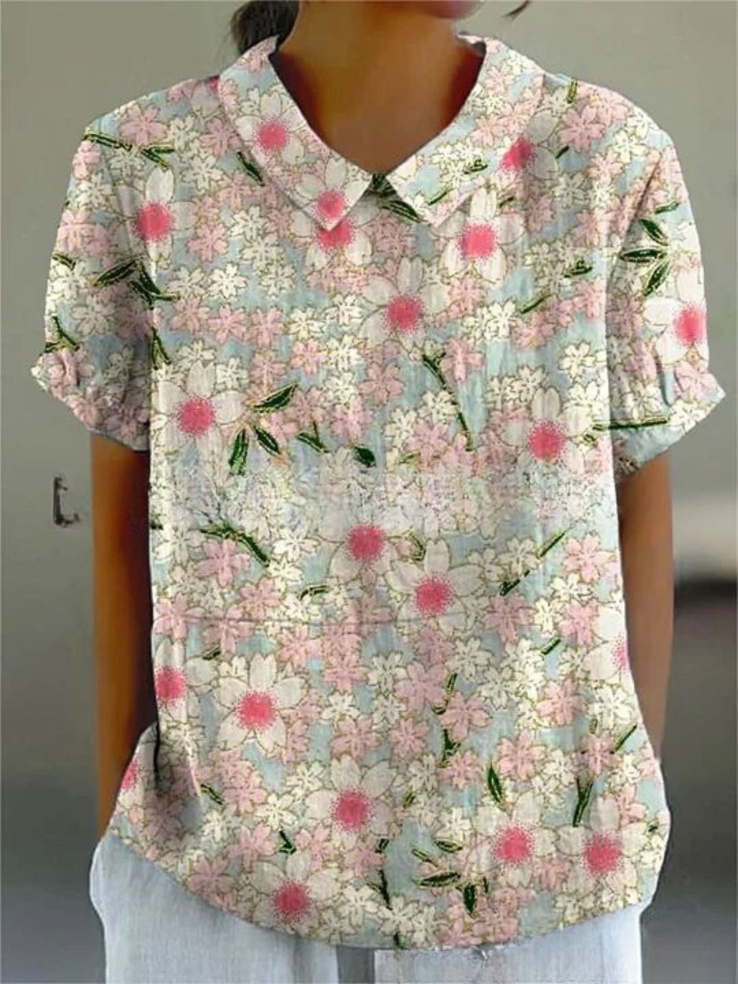 Women's elegant floral blouse with short sleeves and Peter Pan collar, featuring a vibrant floral pattern for stylish summer 