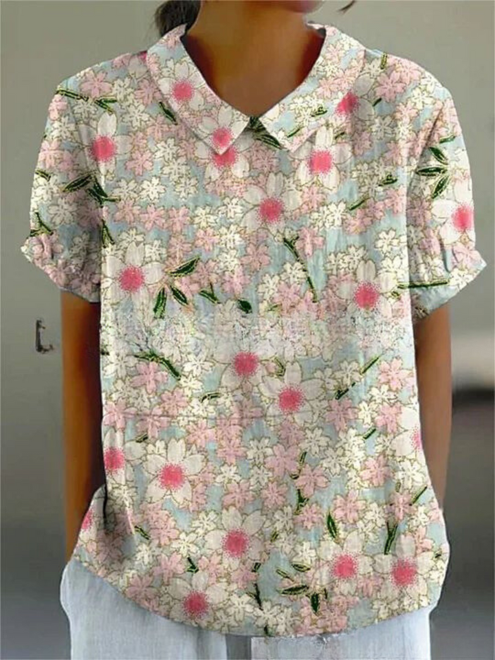 Women's elegant floral blouse with short sleeves and Peter Pan collar, featuring a vibrant floral pattern for stylish summer 