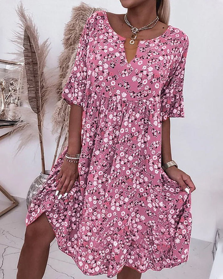 Women's elegant floral V-neck midi dress, vibrant pattern, flattering fit, perfect for garden parties and casual outings.