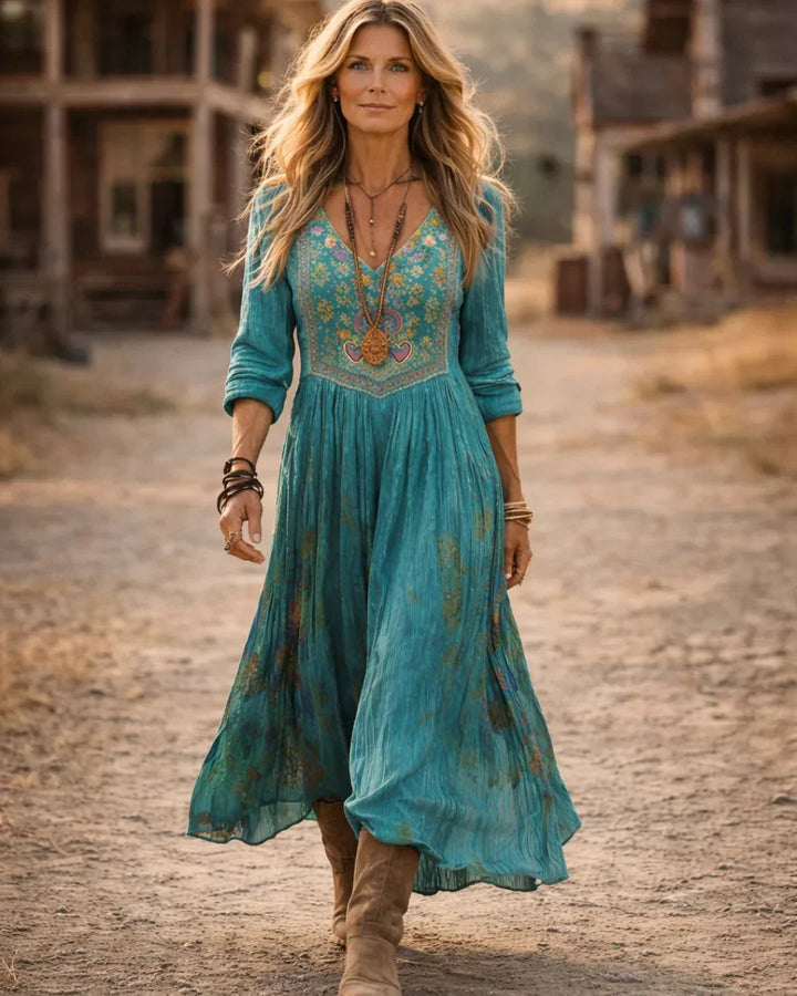 Bohemian V-neck long sleeve maxi dress for women, featuring intricate embroidery & flowy silhouette. Perfect for summer.