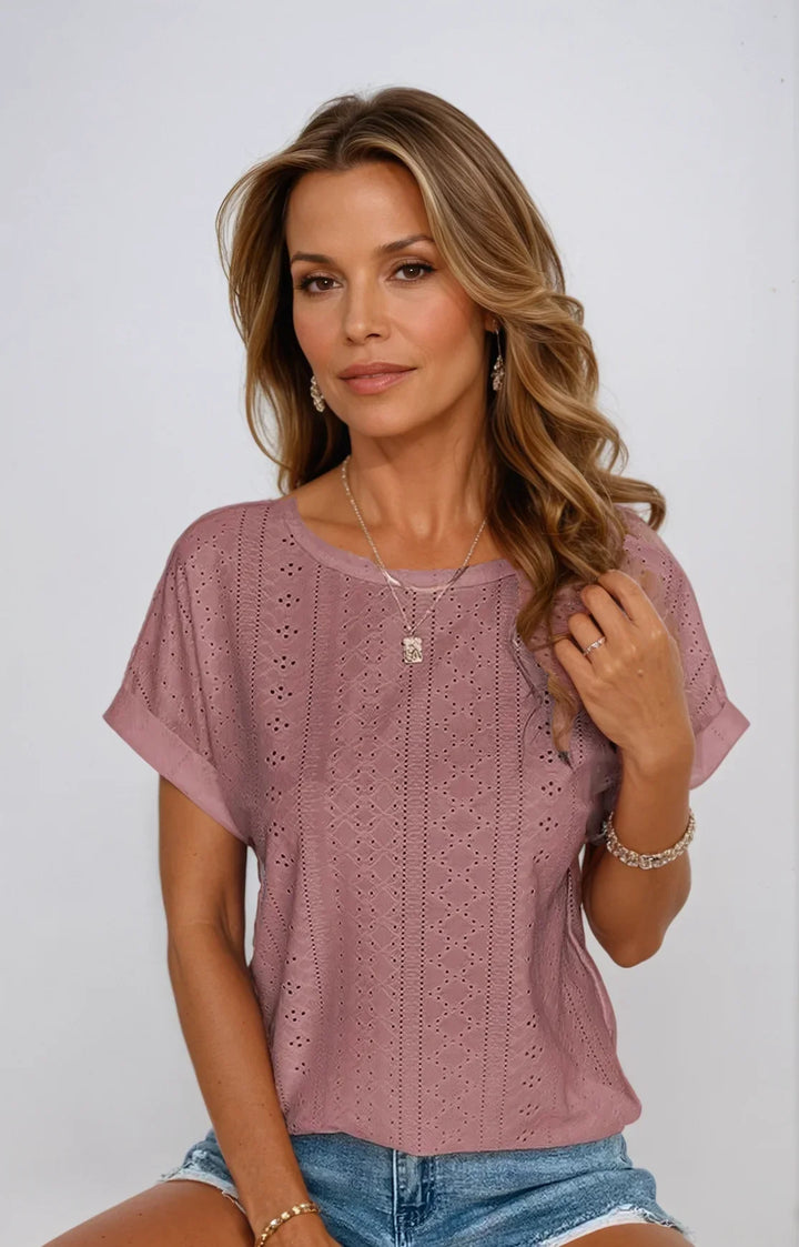 Stylish women's eyelet crew-neck blouse. Short sleeve top for spring and summer chic style.