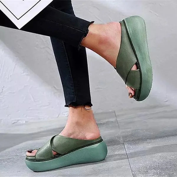 Elegant women's open-toe flat sandals with stylish cross-straps, ideal slip-on summer footwear.