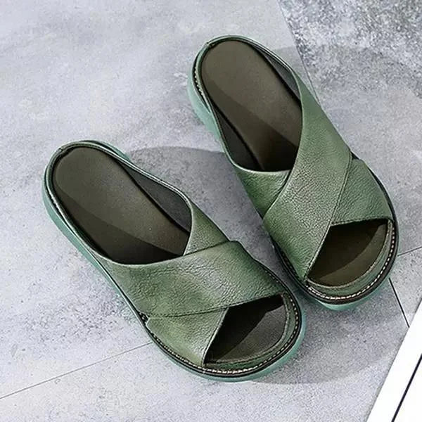 Women's comfortable cross-strap flat sandals in a neutral tone, perfect for summer casual everyday wear.