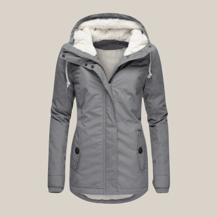Close-up of the quilted pattern & cozy fleece-lined hood on a women's winter jacket.