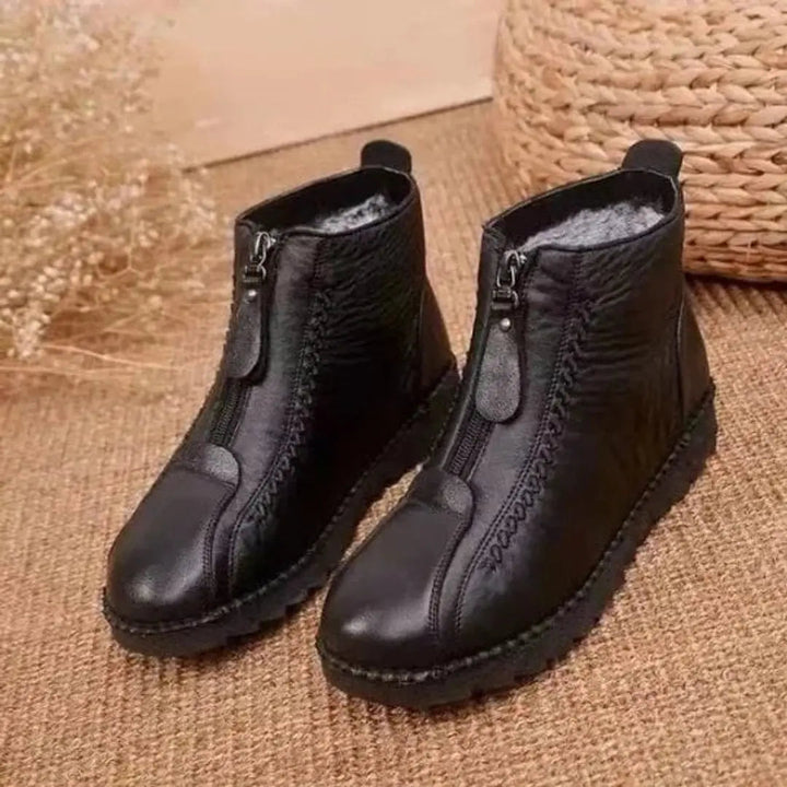 Durable women's non-slip zip-up ankle boots, providing warmth & stability for cold weather outdoor activities.