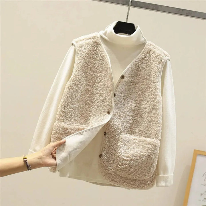 Cozy sherpa fleece gilet for women. Reversible button-up puffer vest, ideal for casual winter style.