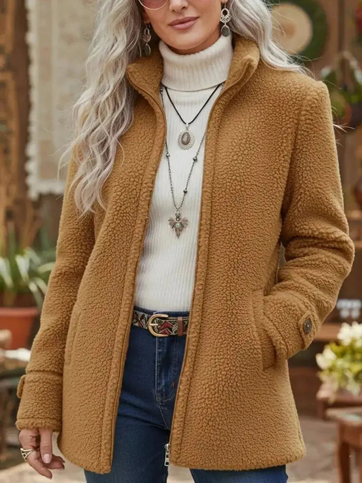 Warm women's winter coat with a cozy fleece lining, full-zip closure, and a protective stand collar.