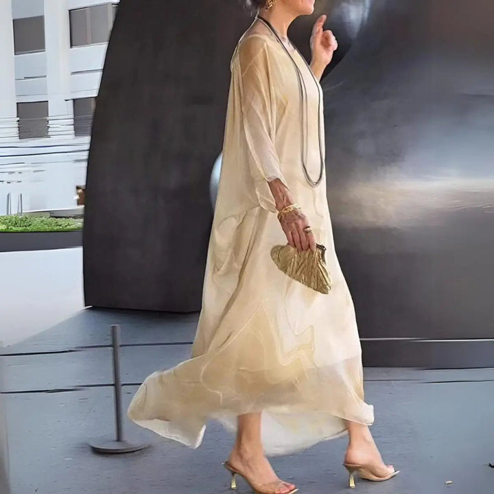 Versatile women's floaty maxi dress, long batwing sleeves & round neck. Suitable for daytime chic & events.