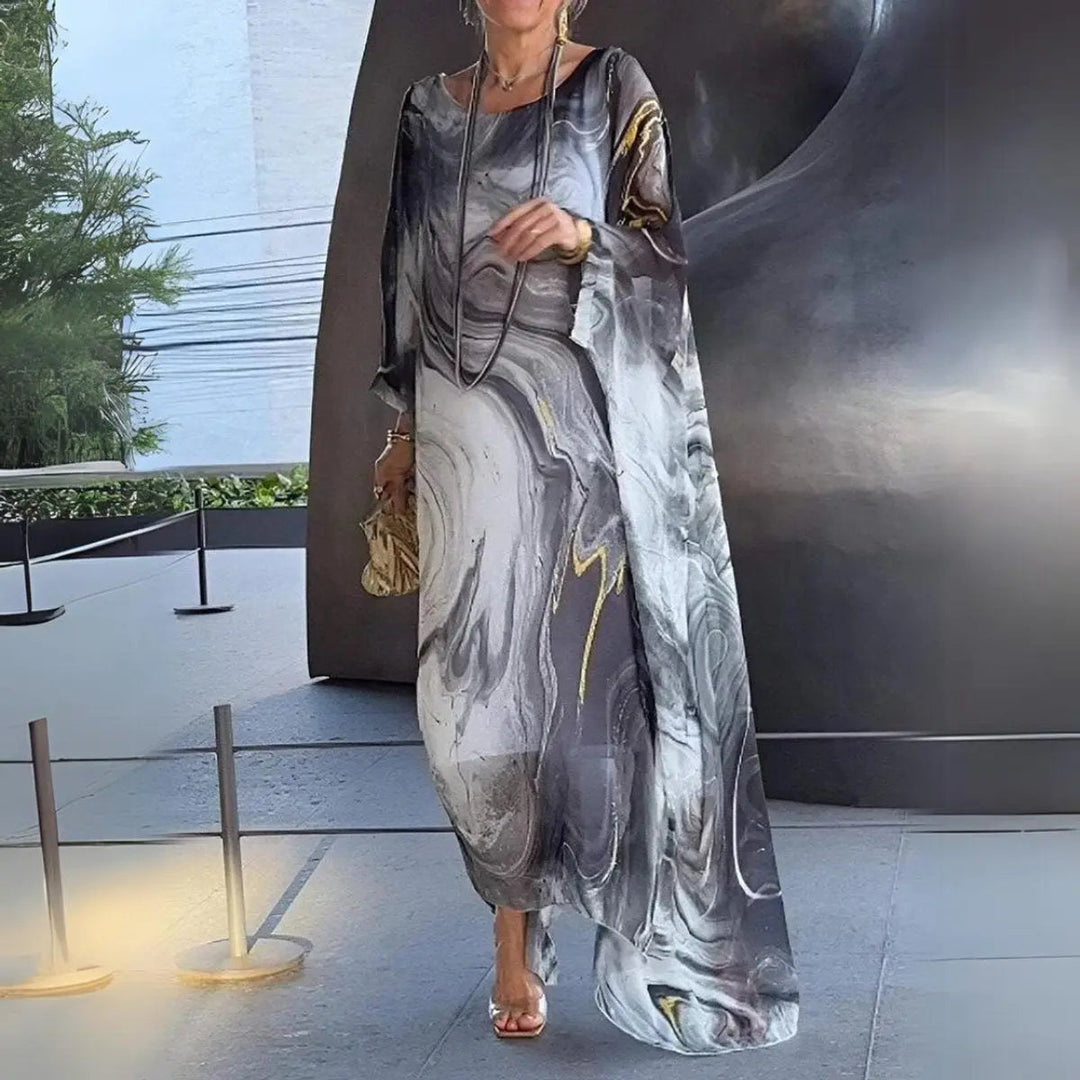 Plus size women's floaty maxi dress with long batwing sleeves & round neck. Ideal for wedding guests & parties.