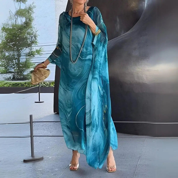 Chic women's long sleeve batwing maxi dress, round neck, floaty design. Perfect for elegant evening occasions.