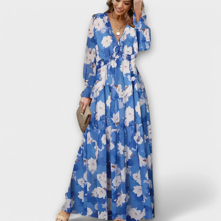 Chic women's floral print maxi dress. Details include a flattering ruffled V-neck & delicate tiered skirt.