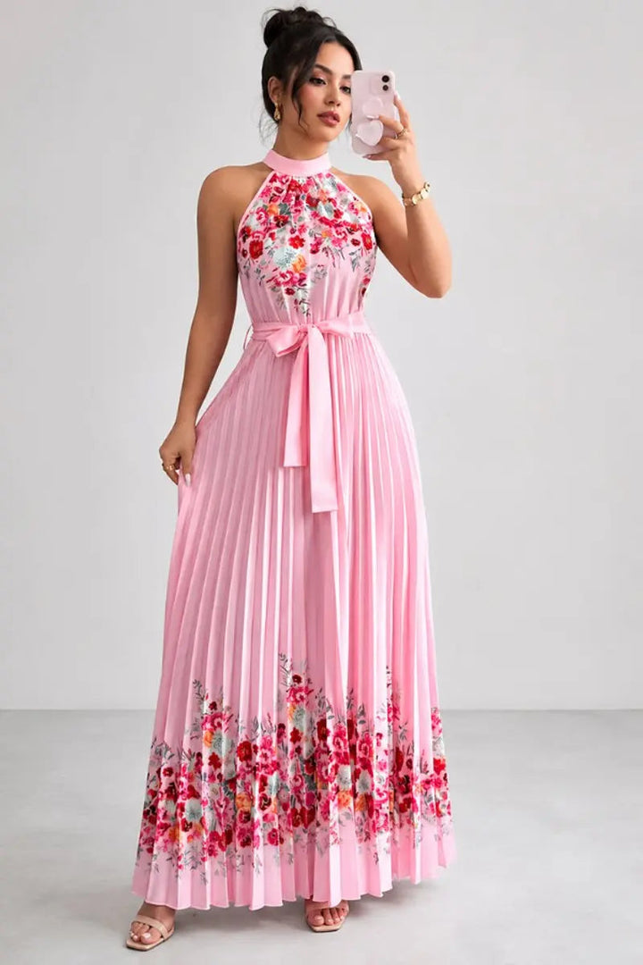 Sophisticated women's halter neck maxi gown with delicate floral print and flowing pleats.