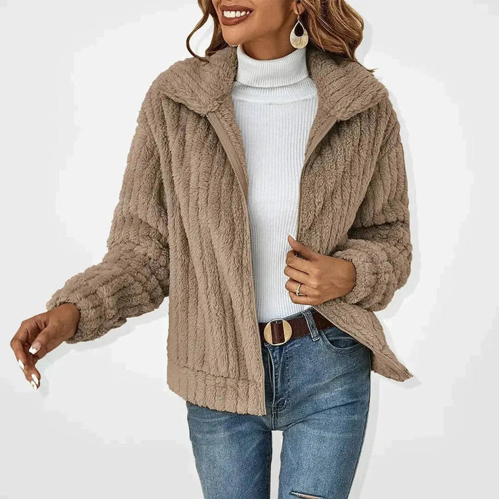 Fashionable women's fluffy quilted jacket with a convenient zip-up, versatile for cozy autumn looks.