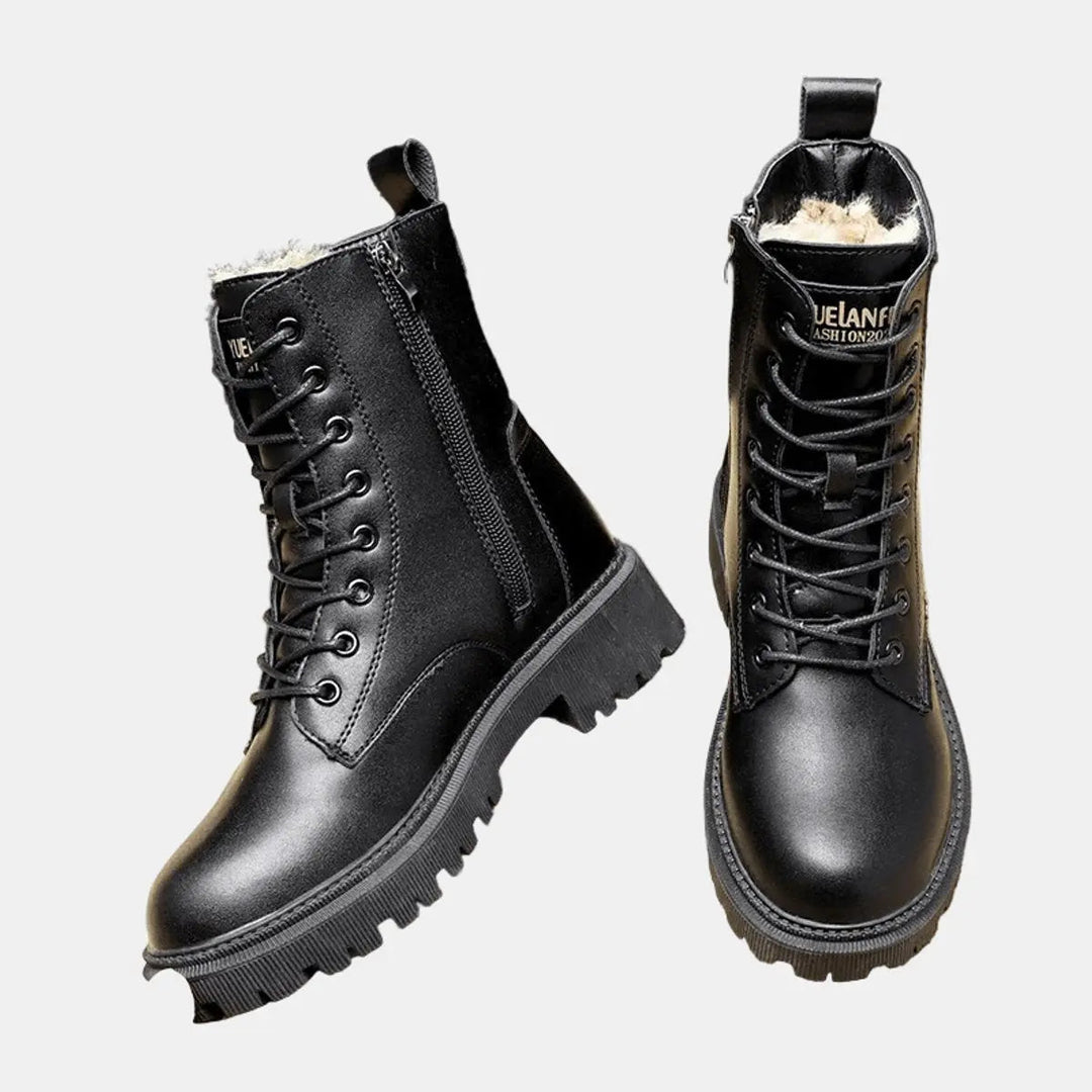 Women's black lace-up combat ankle boots with fur lining, designed with a chunky sole for stylish and warm winter wear.