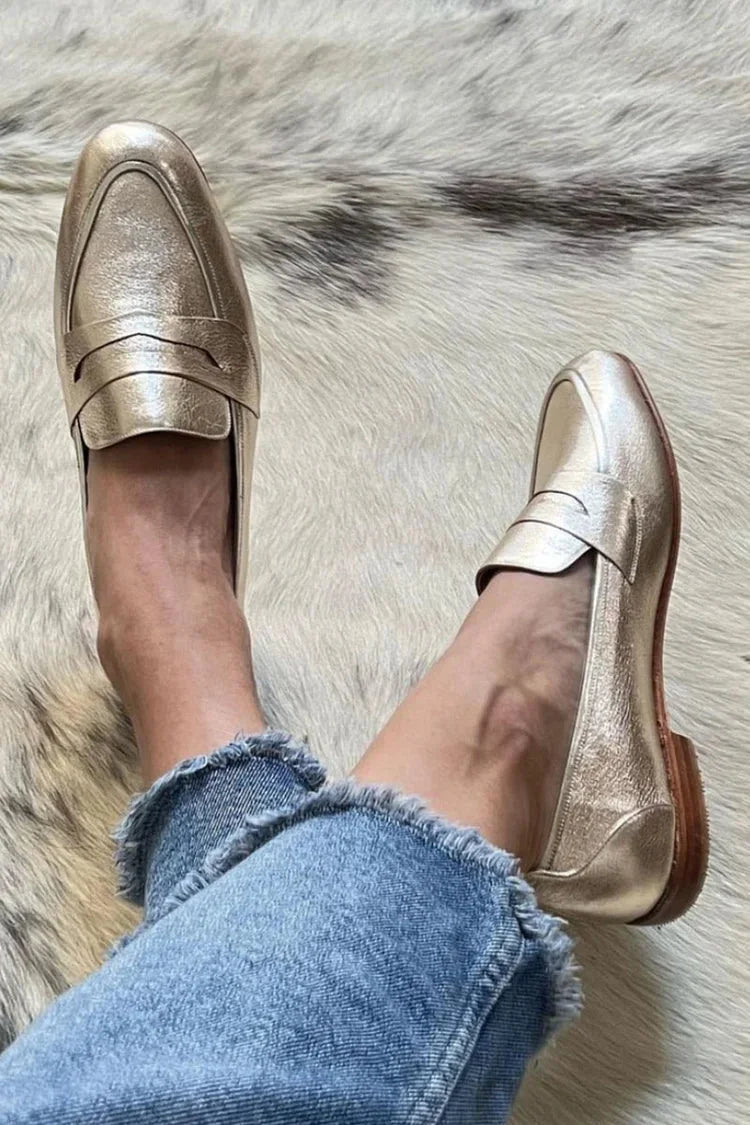 Elegant women's gold metallic slip-on loafers with a stylish pointed toe for comfortable dressy or smart casual wear.