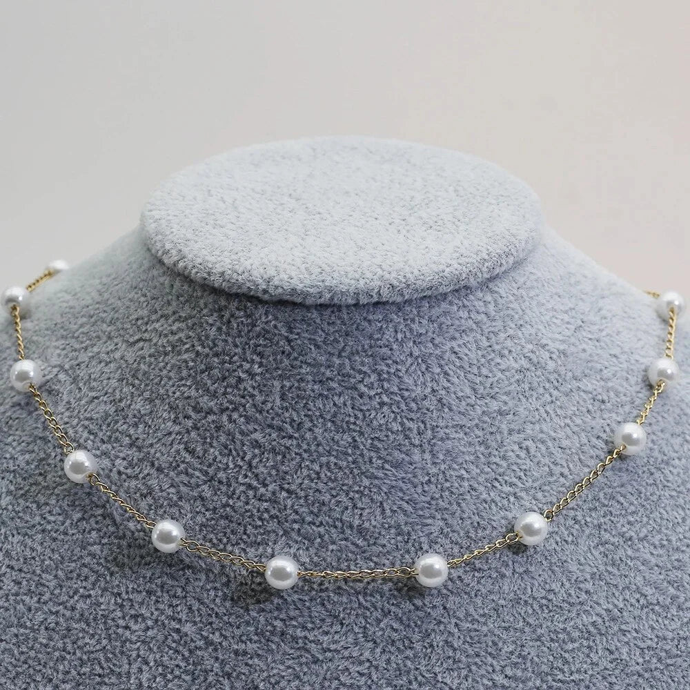 Stylish dainty gold tone pearl necklace for women. Delicate choker design, perfect for elegant wear.