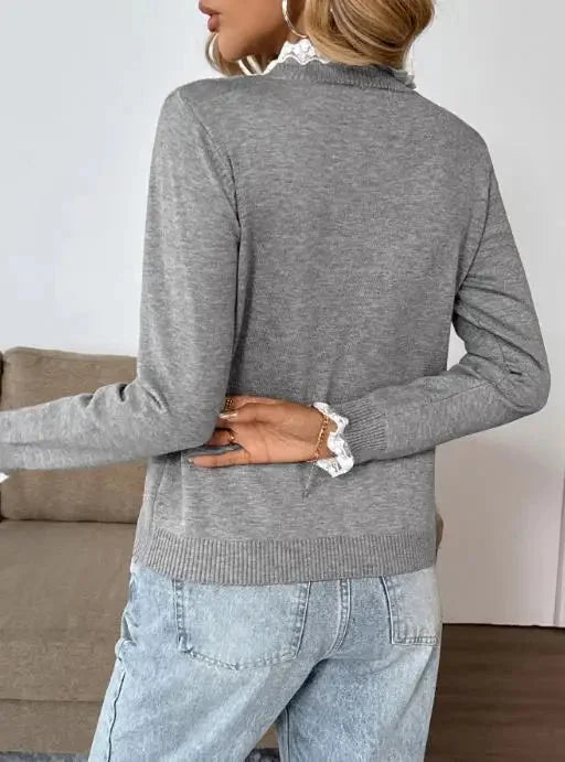 Soft knit grey women's long-sleeve sweater featuring a sophisticated lace-trim mock-neck. Retro vintage style top.