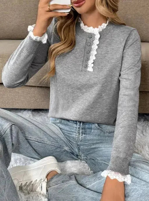 Woman models a chic grey retro long-sleeve sweater with an exquisite lace-trim mock-neck. Elegant fall casual wear.