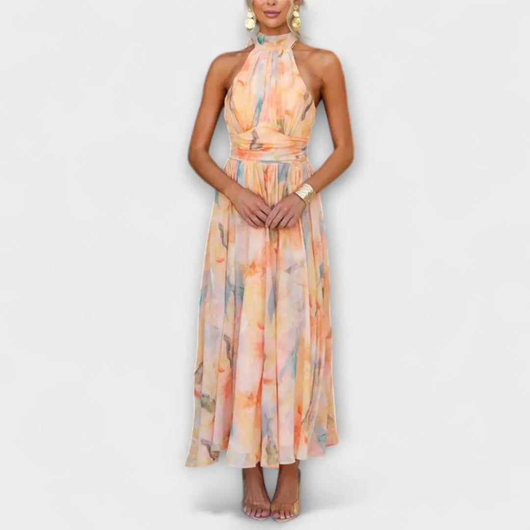 Elegant women's halterneck maxi dress with vibrant watercolor print, perfect for cocktail parties or wedding guests.