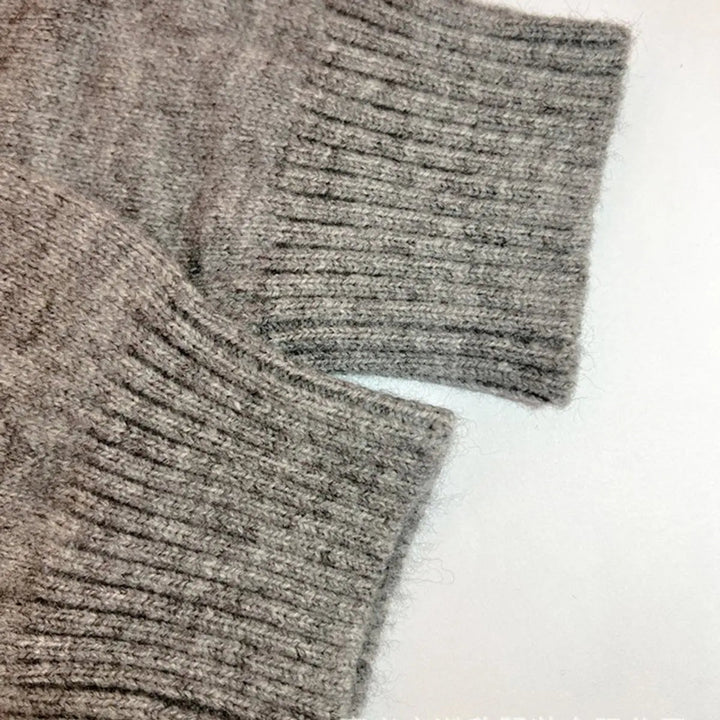 Women's cozy longline hooded cardigan jacket featuring a unique statement trim. Stylish open-front knit for autumn.