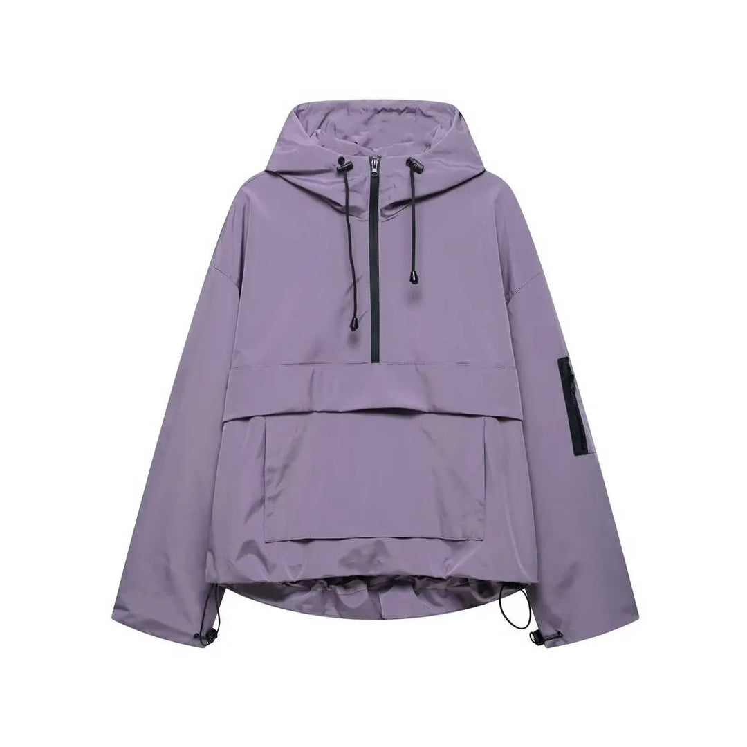 Lightweight women's oversized hooded anorak. Quilted half-zip windproof pullover for spring and fall fashion.