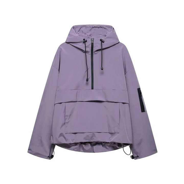 Lightweight women's oversized hooded anorak. Quilted half-zip windproof pullover for spring and fall fashion.