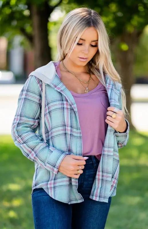 Trendy women's plaid button-down shirt jacket with hood, ideal for bohemian-inspired leisure wear.