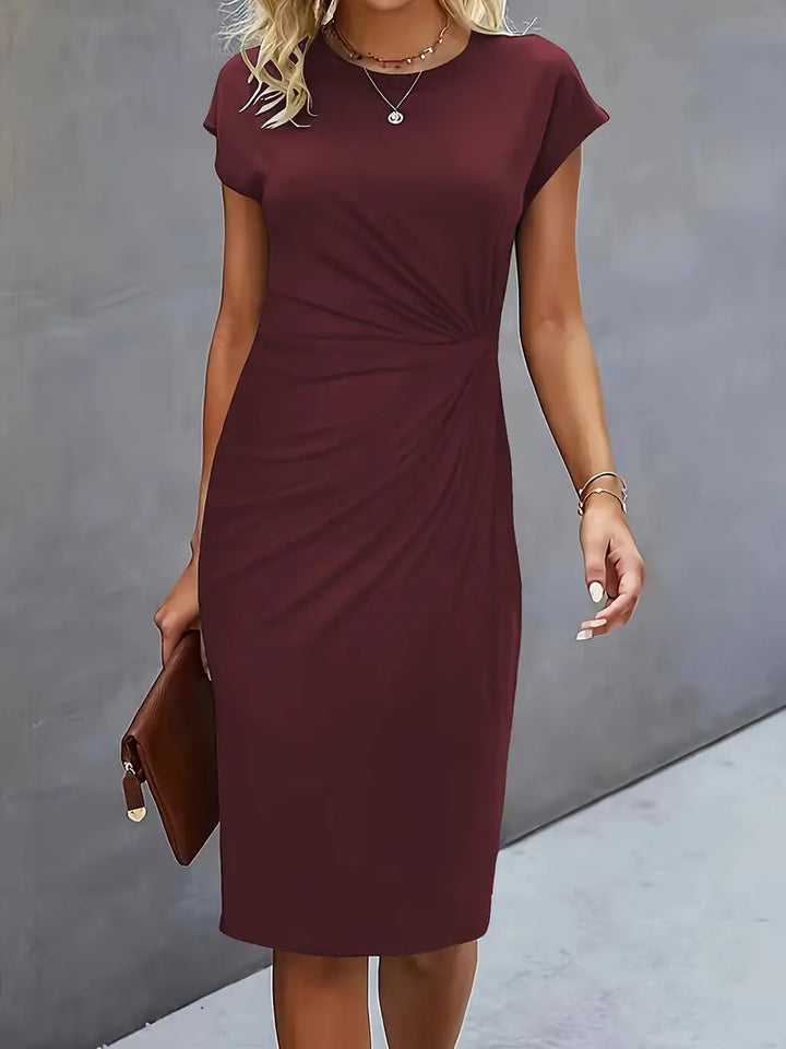 Women's knee-length sheath dress with cap sleeves and ruched waist, offering a flattering fit and elegant silhouette for any 