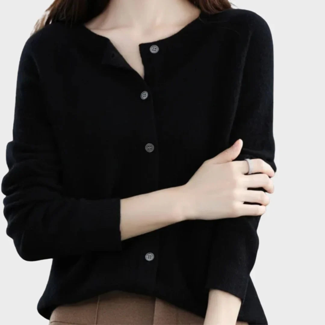 Close-up of elegant buttons on a women's crew-neck knit cardigan. Detail of button-front closure.