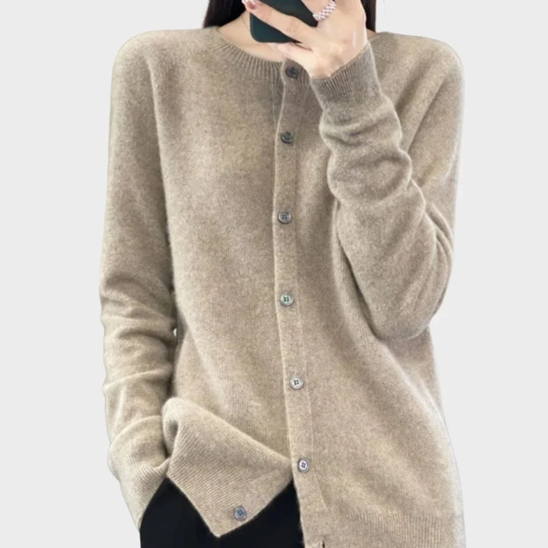 Textured close-up of a cozy women's knit cardigan sweater. Shows the soft fabric & quality knitwear.