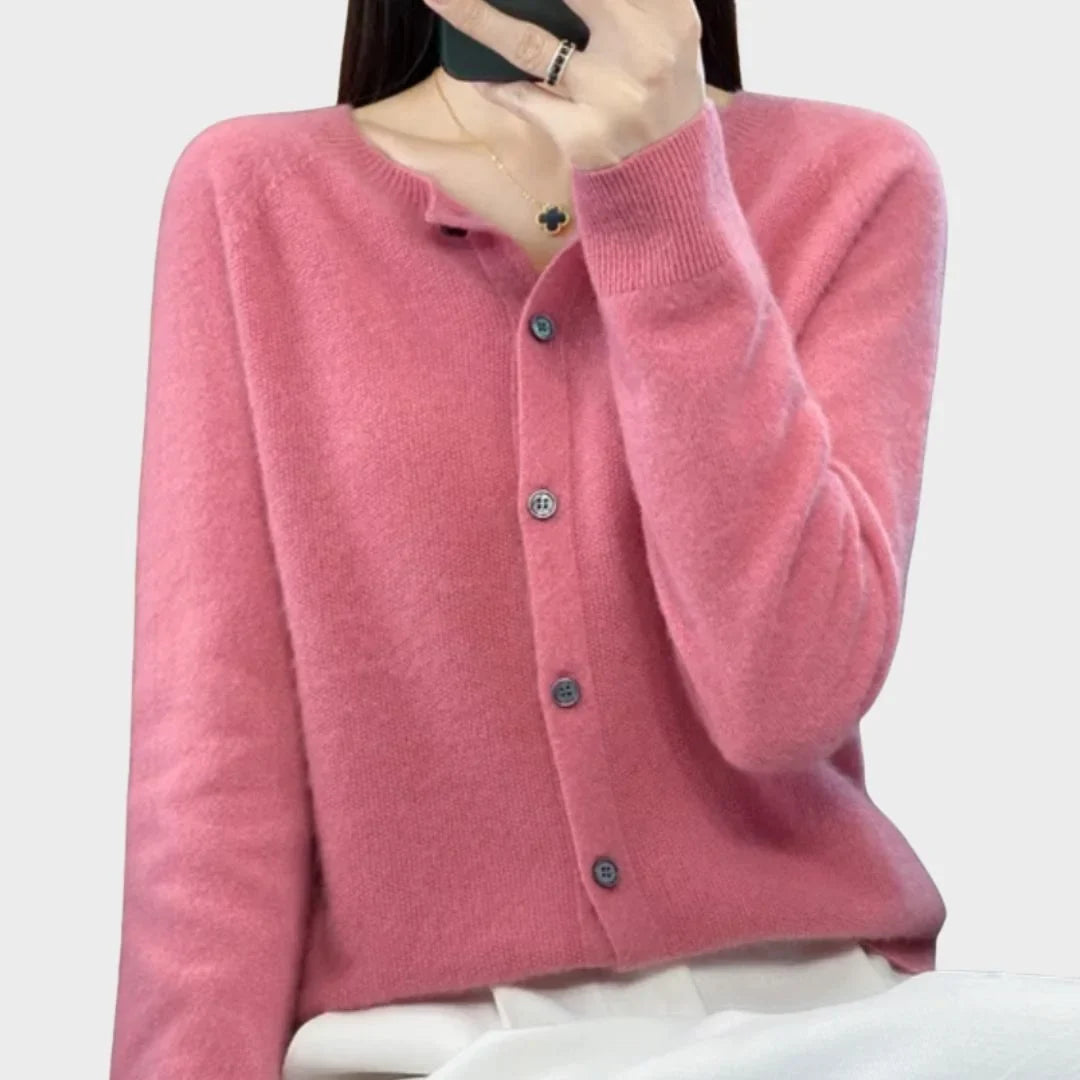 Back view of a women's crew-neck knit cardigan sweater. Shows comfortable fit and long sleeves.