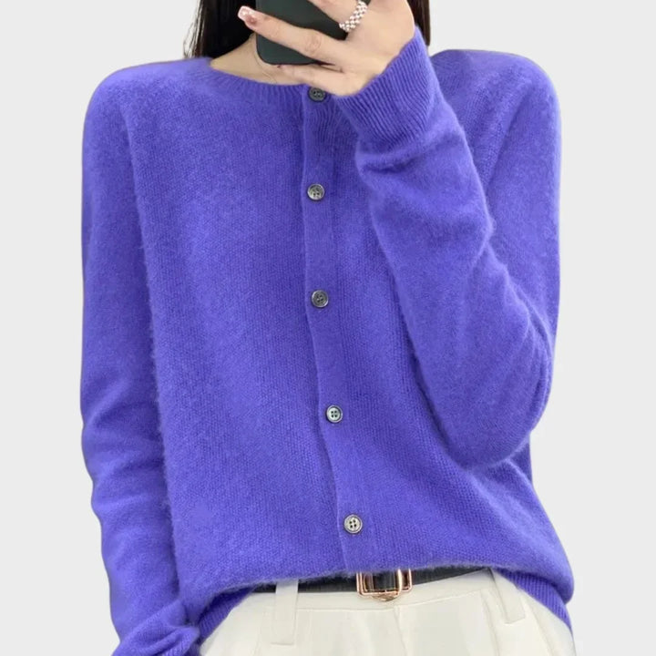 Folded women's crew-neck cardigan sweater. Ready for comfortable wear, showcasing the soft knitwear.